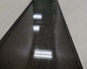 Freshly waxed glossy hallway floor in a clean commercial corridor